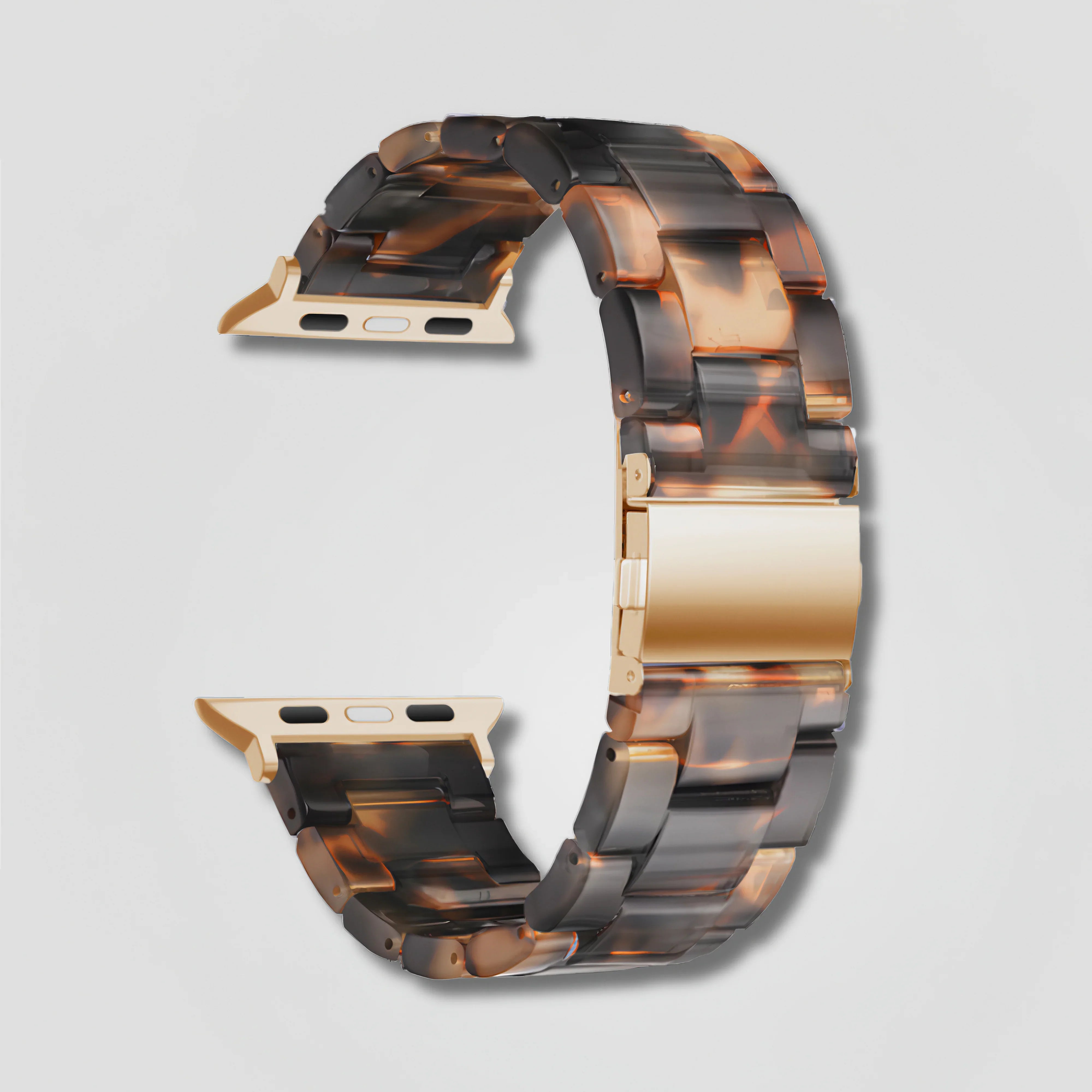 Image of Tortoiseshell resin and gold clasp Apple Watch band on white background