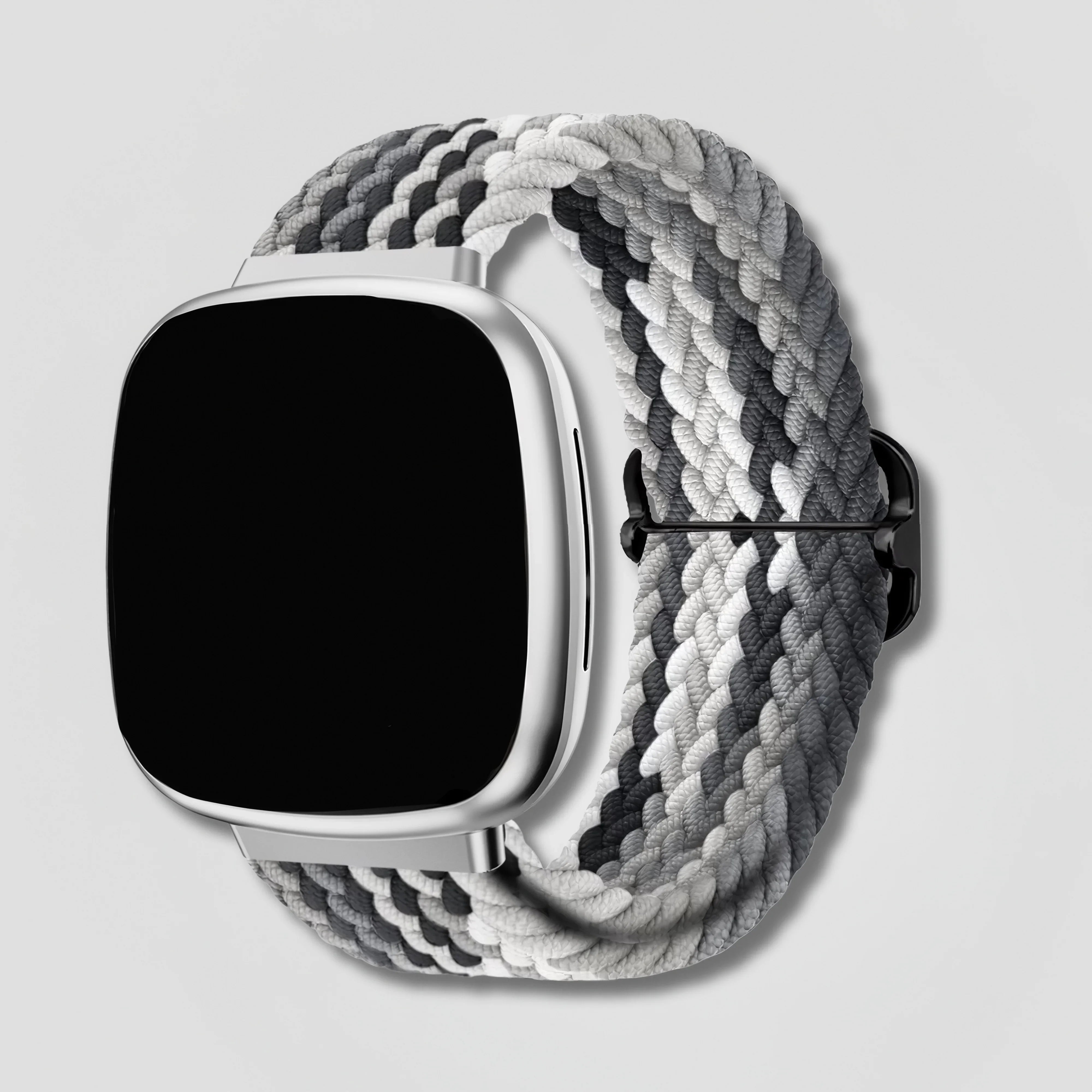 Image of Fitbit smartwatch with black and white braided loop band on light background