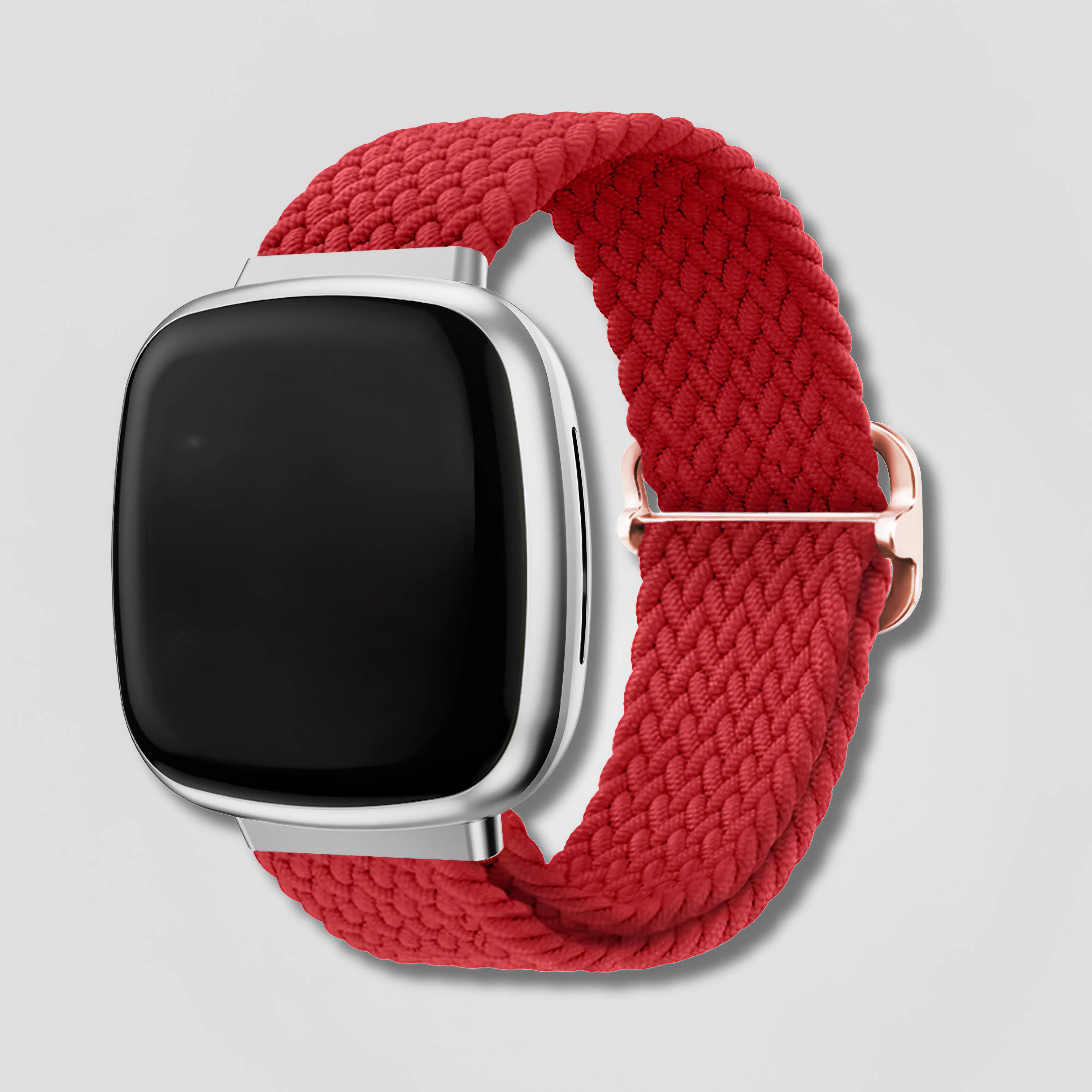 Red braided loop band on Fitbit Versa 3 or Sense smartwatch, silver case, white background