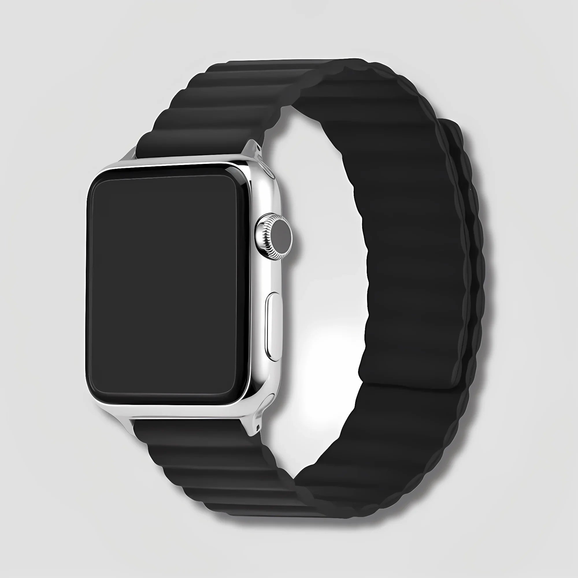 Image of Black magnetic silicone band on silver Apple Watch against light gray background