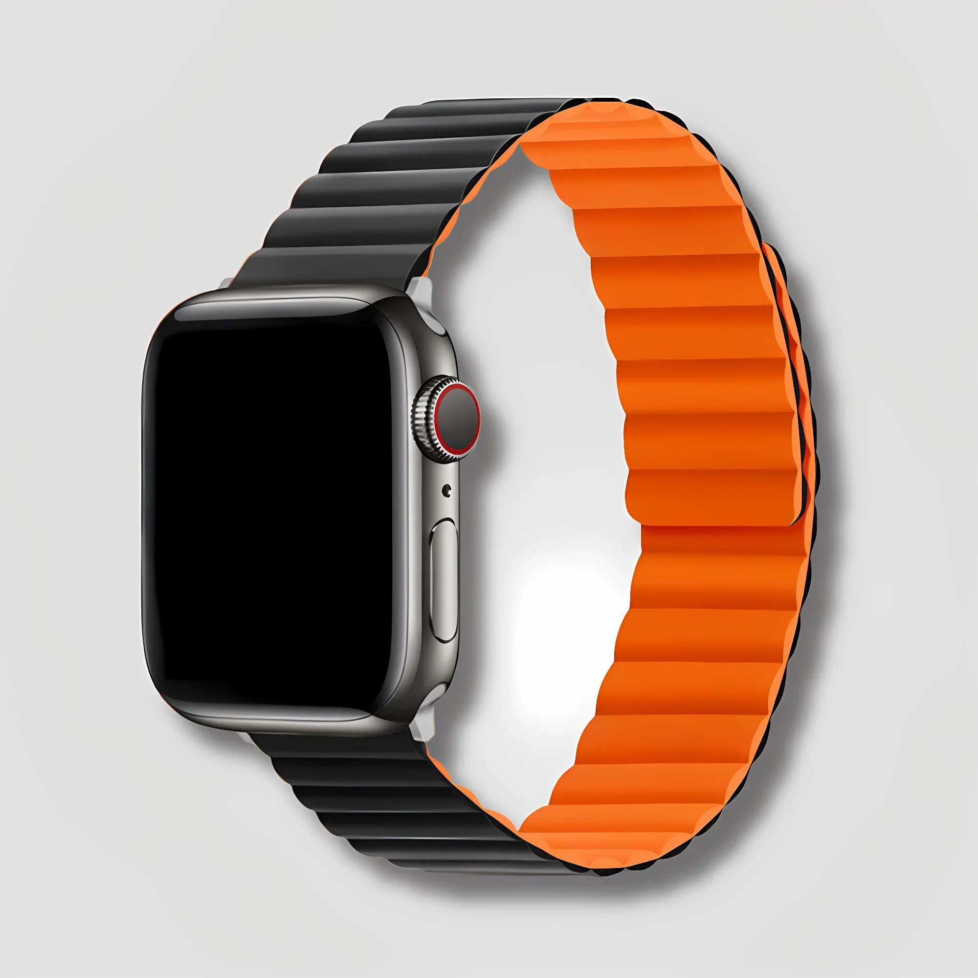 Apple Watch with black and orange magnetic silicone band on light background